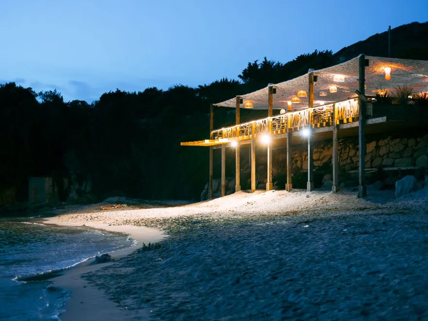Beach restaurant glowing at night
